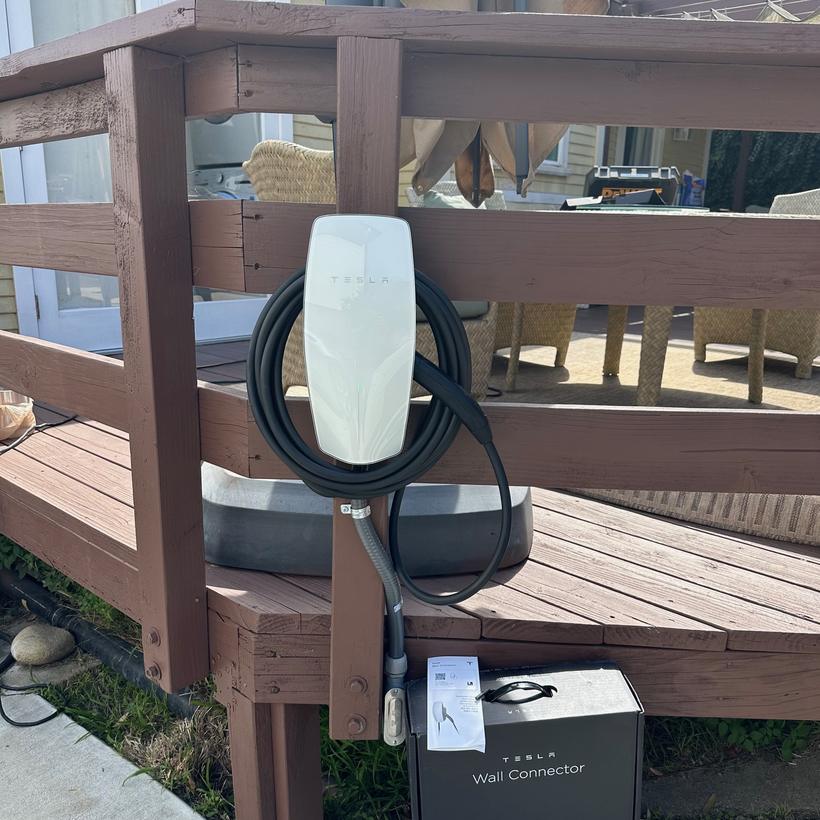 A charging unit and associated equipment mounted on an exterior wall
