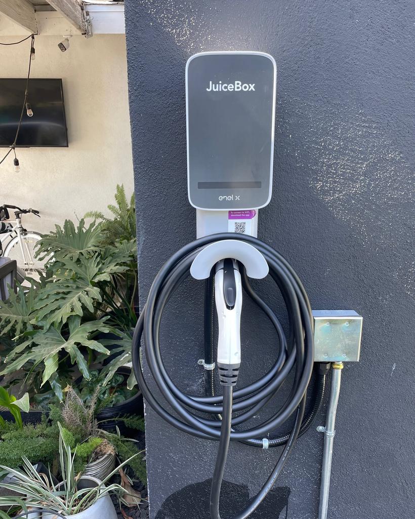 A hardwired Level 2 charging unit on an exterior wall