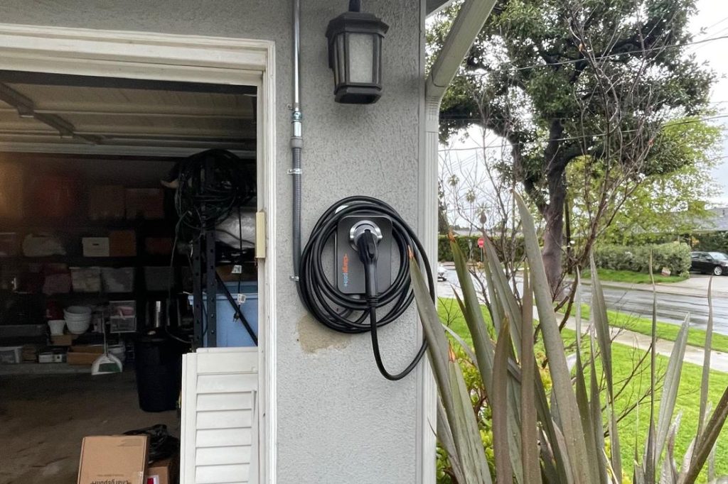 An EV charging on a residential driveway